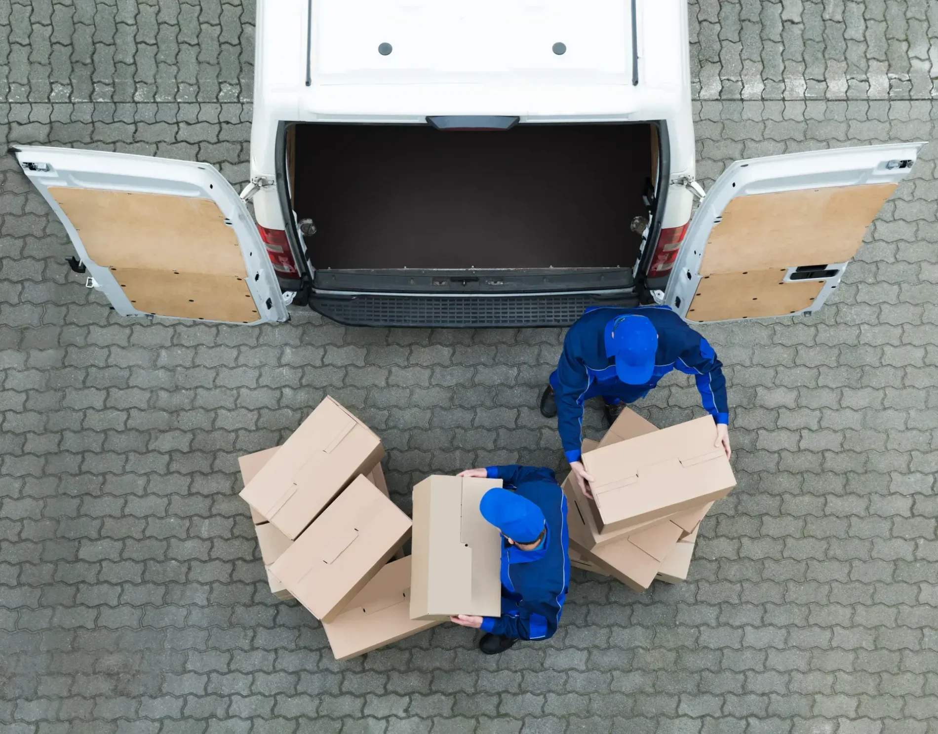 two men loading packages into a van